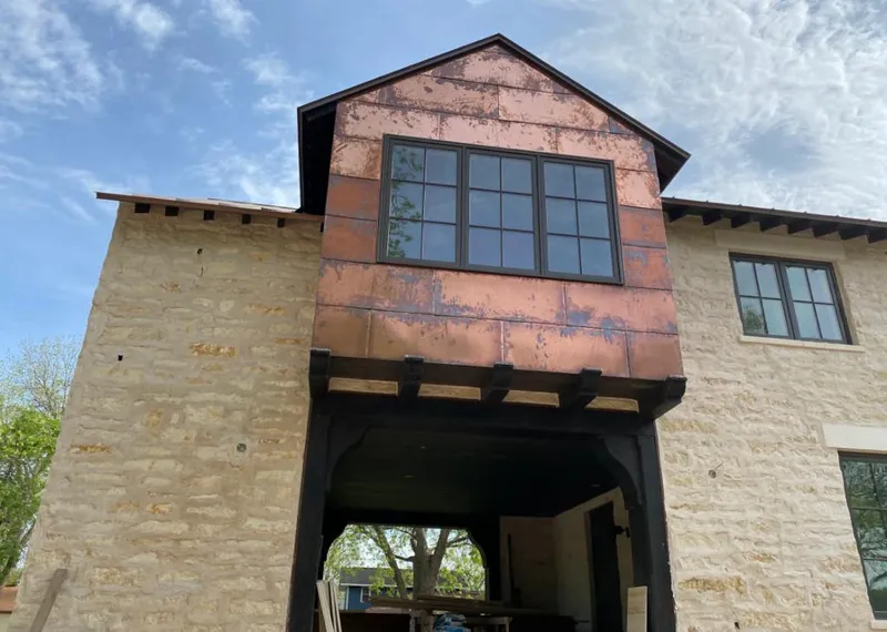Copper metal panel facade on a stone building for Skylight Installation in Ukiah